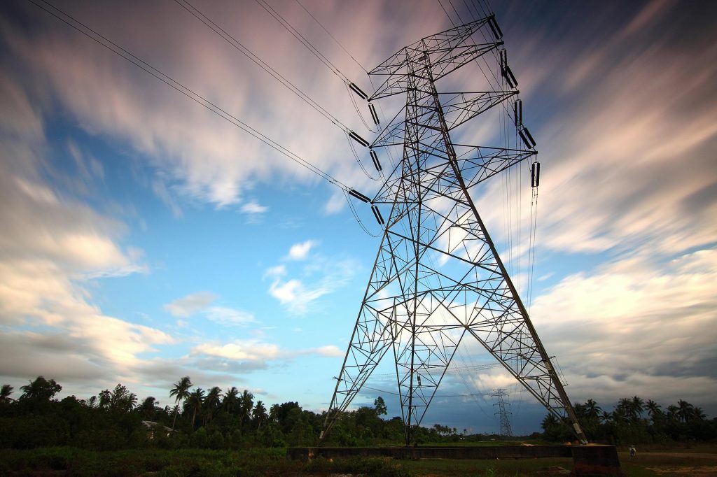 Stunning view of a towering power line against a vibrant sky, showcasing energy infrastructure in nature.