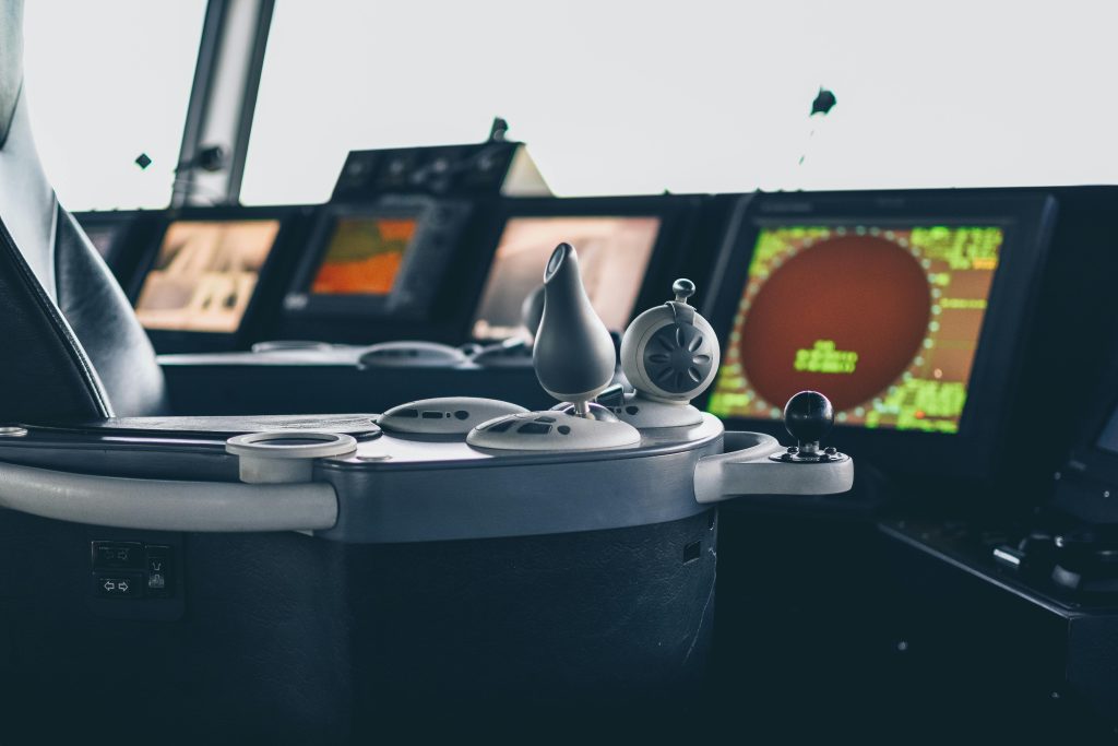 Close-up view of ship navigation controls and radar screens, capturing maritime technology.