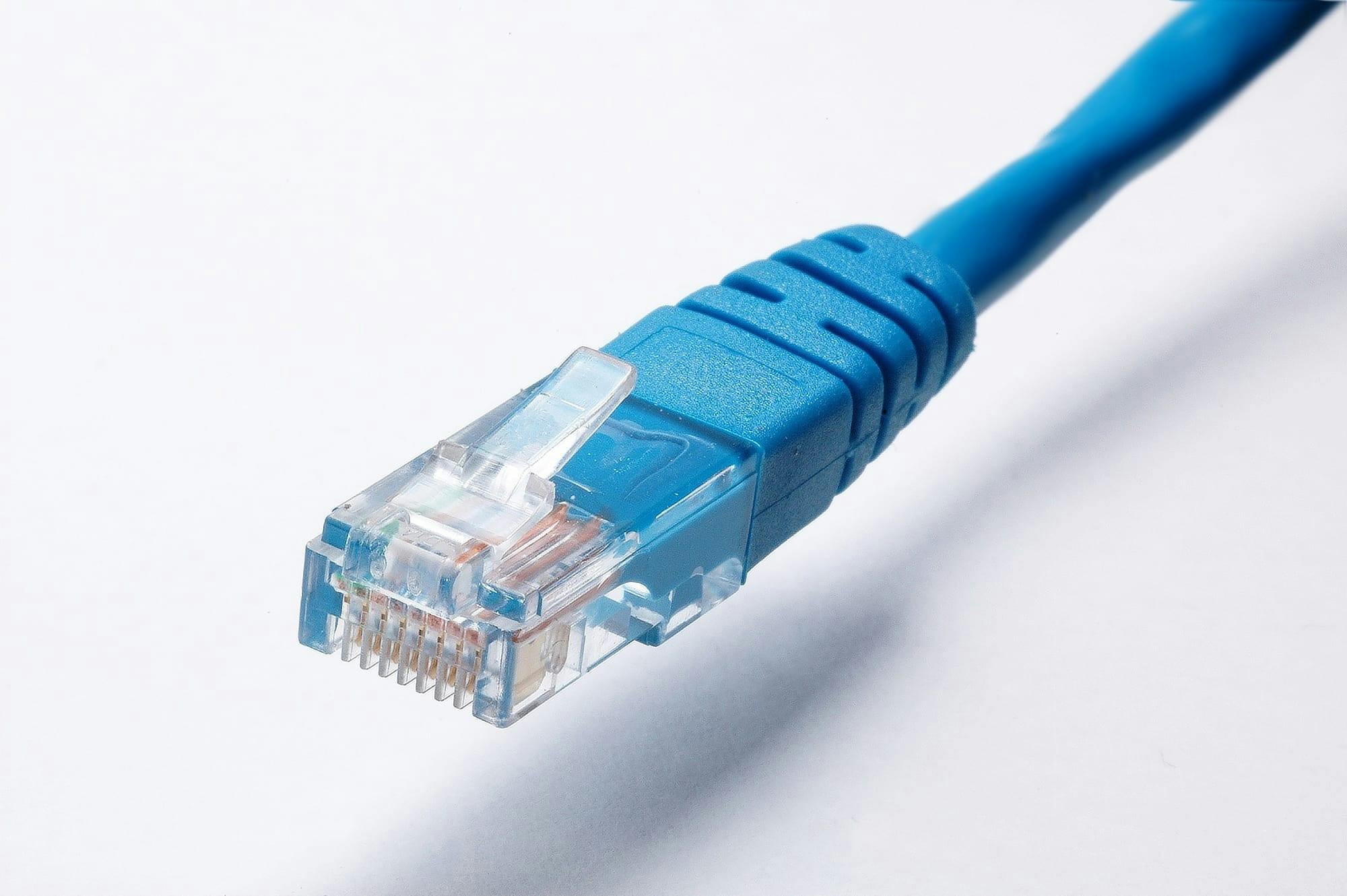 High-quality image of a blue Ethernet cable plug on a white background, ideal for tech themes.