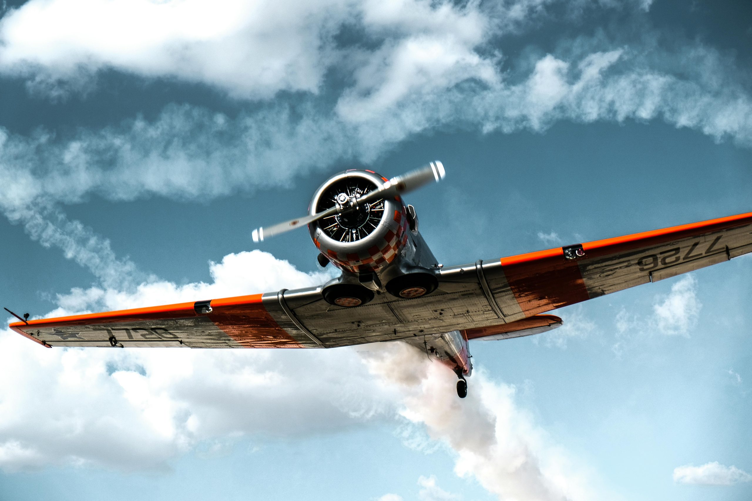 A stunning vintage airplane flying through a clear sky, showcasing classic aviation technology.