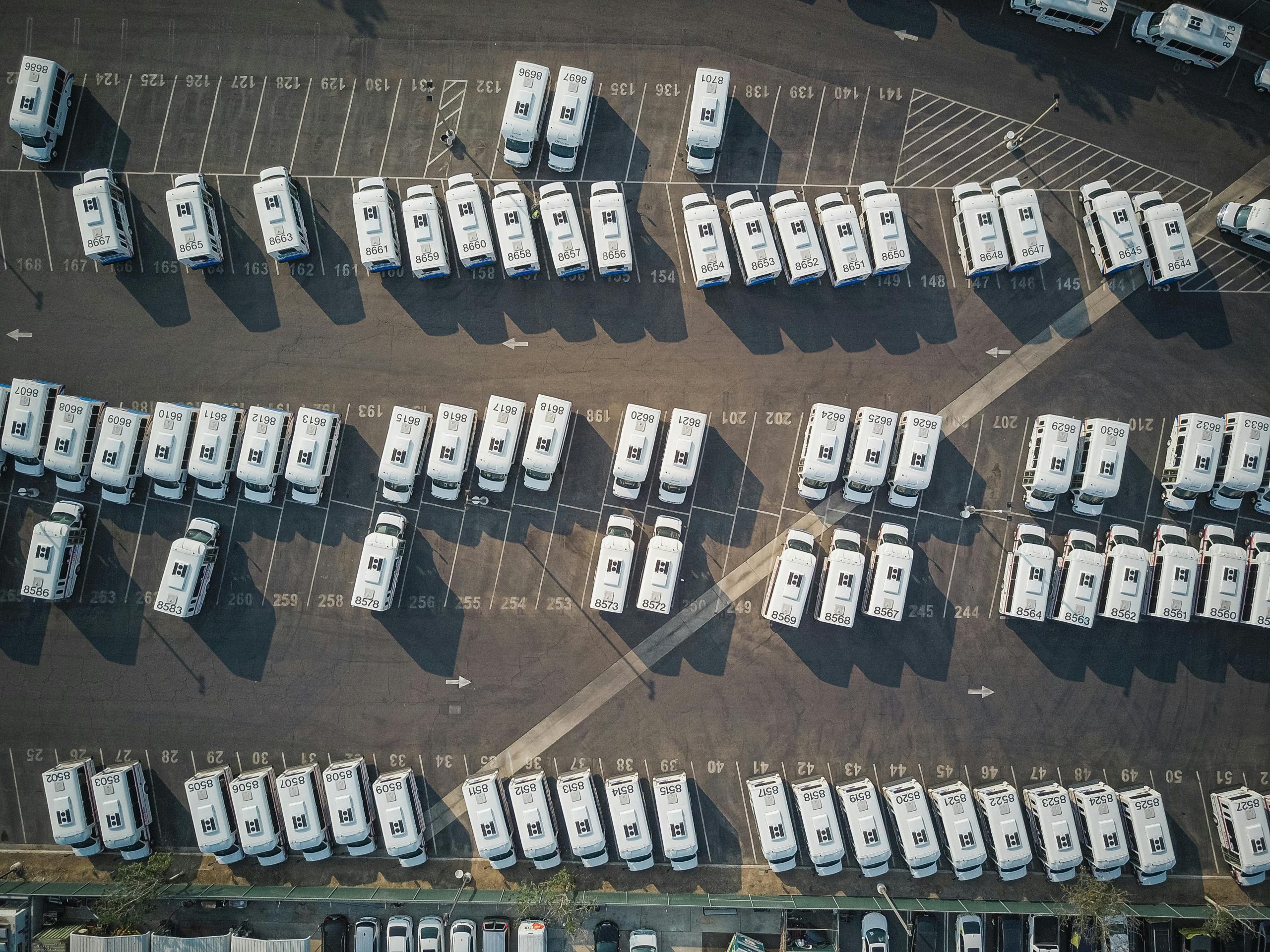 Aerial perspective showcasing a parking lot filled with parked camper vans.