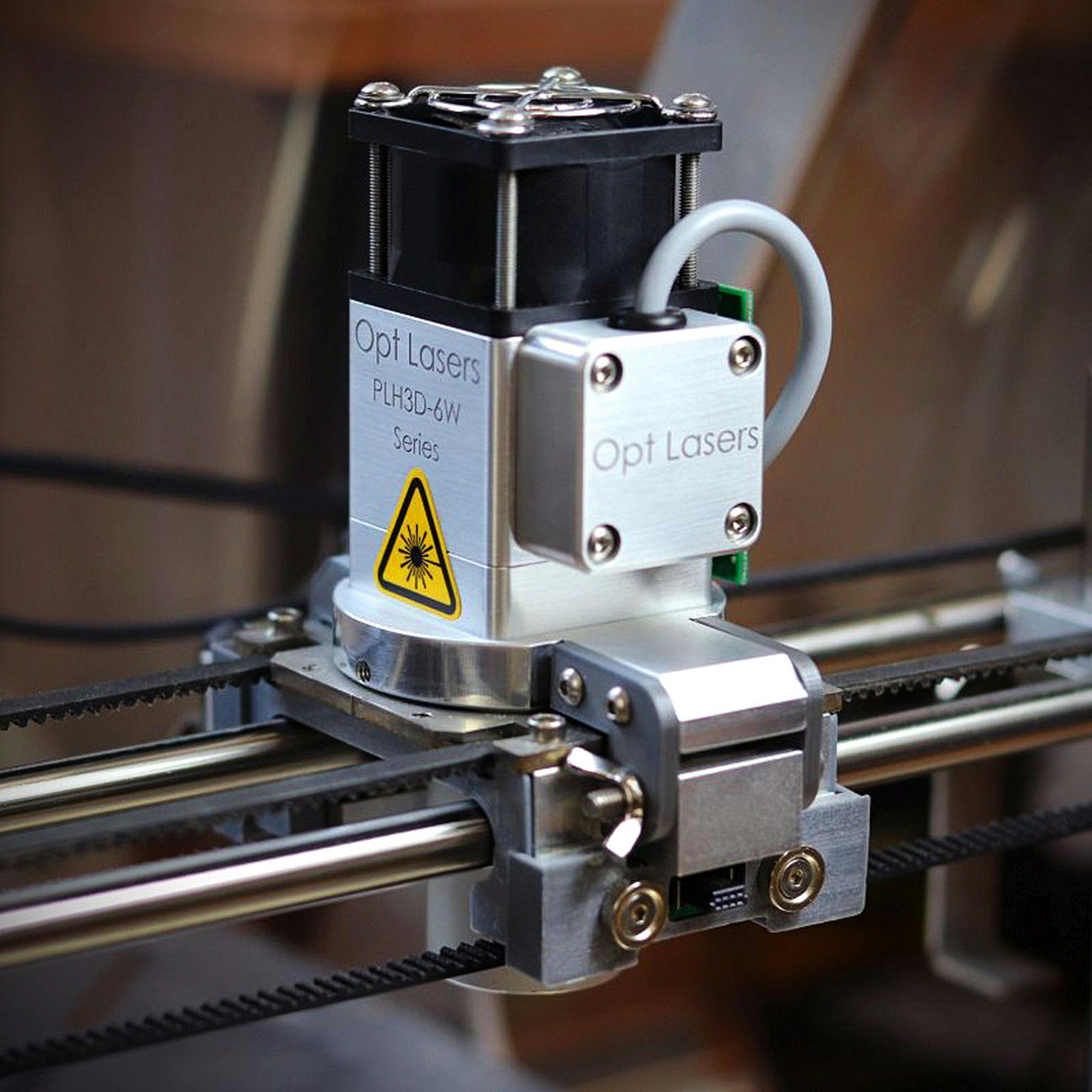 Close-up of a laser cutter used for precision cutting in industrial settings.